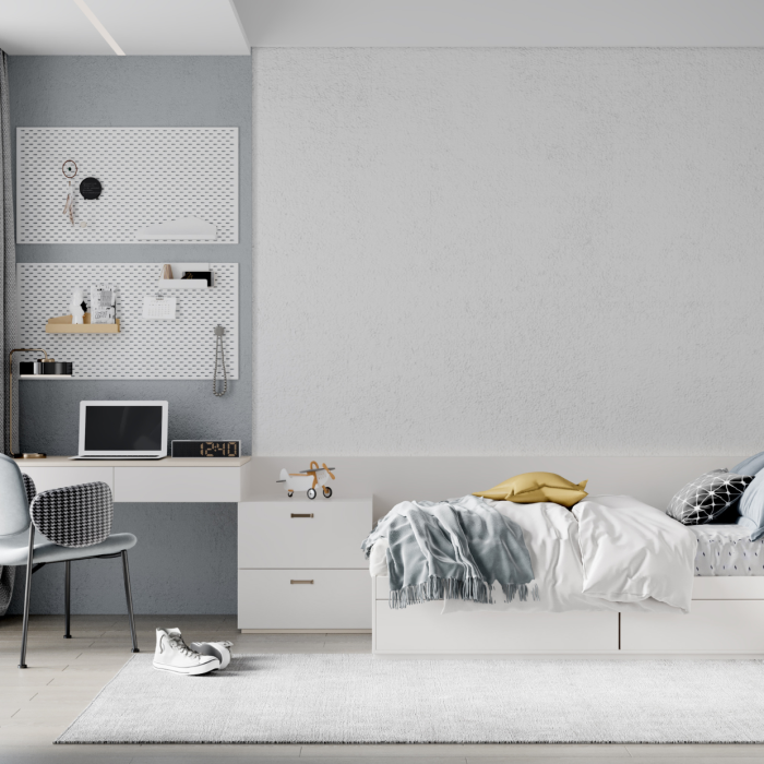 Quarto de adolescente com espaço otimizado e minimalista tendo a parede pintada de branco e cinza dividindo o espaço entre cama e mesa de estudo